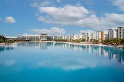 a large pool of blue water in front of buildings at Evermore Orlando Resort in Orlando
