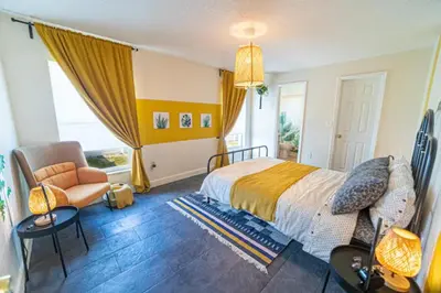 a bedroom with a bed and a chair and a window at Newly Updated 3 Bedroom Home in Kissimmee