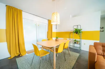 a dining room with a table and yellow chairs at Newly Updated 3 Bedroom Home in Kissimmee