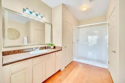 a bathroom with a sink and a shower at Stunning 2BR Condo with Pool, near Disney! in Orlando