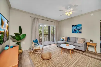 a living room with a couch and a table at Bright 3BR Condo With Pool, Close to Disney! in Orlando