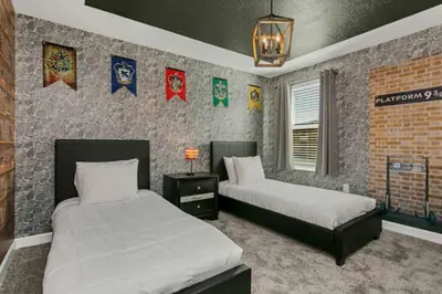 a bedroom with two beds and a brick wall at Amazing Family Home 8min Disneyworld Pool/Spa Sleeps 24 in Kissimmee