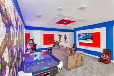 a living room with a tv and a video game at Amazing Family Home 8min Disneyworld Pool/Spa Sleeps 24 in Kissimmee