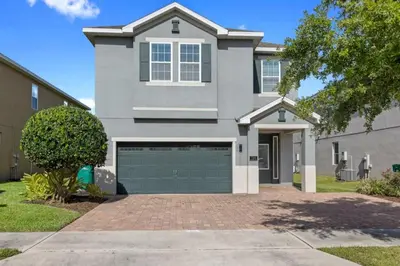 a large house with a garage in front of it at 7500 Marker av in Orlando