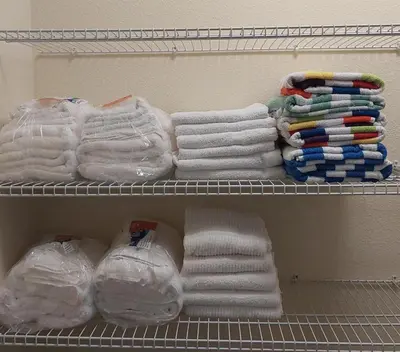 a closet filled with white towels and other towels at 7500 Marker av in Orlando
