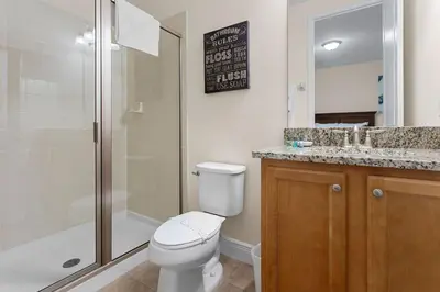 a bathroom with a toilet and a shower and a sink at 7500 Marker av in Orlando
