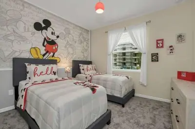 a bedroom with two beds and a mickey mouse mural at 3 BR 2 BA Deluxe Condo 8min to Disneyworld STL105 in Kissimmee