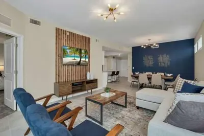 a living room with a couch and a table at 3 BR 2 BA Deluxe Condo 8min to Disneyworld STL105 in Kissimmee