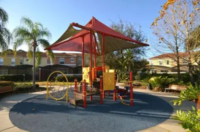 a playground in a park with a red structure at Peaceful Quiet Pool Home 5 min from Disney! townhouse in Orlando