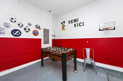 a room with a table and a chair in it at Luxury Home With Private Pool And Water Park & Resort Access Near Disney At Encore Resorts Reunion - 240Mn in Kissimmee