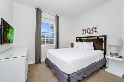 a white bedroom with a large bed and a window at Luxury Home With Private Pool And Water Park & Resort Access Near Disney At Encore Resorts Reunion - 240Mn in Kissimmee