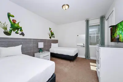a hotel room with two beds and a tv at Luxury Home With Private Pool And Water Park & Resort Access Near Disney At Encore Resorts Reunion - 240Mn in Kissimmee