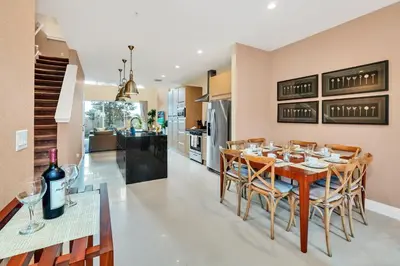 a kitchen and dining room with a wooden table and chairs at Luxury Villa Less Than A Mile From Disneyworld -Bonus Elevator- in Orlando