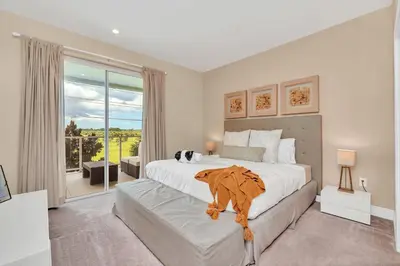 a bedroom with a large bed and a large window at Luxury Villa Less Than A Mile From Disneyworld -Bonus Elevator- in Orlando