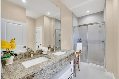 a bathroom with two sinks and a shower at Luxury Villa Less Than A Mile From Disneyworld -Bonus Elevator- in Orlando