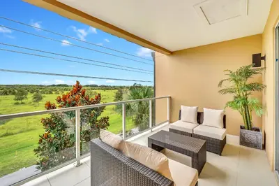 a balcony with a couch and chairs and a table at Luxury Villa Less Than A Mile From Disneyworld -Bonus Elevator- in Orlando