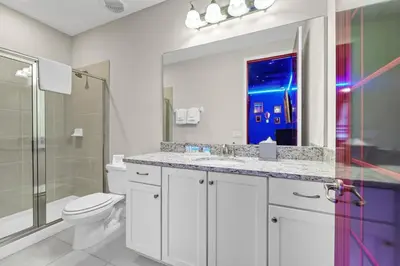a bathroom with a toilet and a sink and a shower at Alluring Home With Private Pool And Waterpark & Resort Access Near Disney At Encore Resorts Reunion - 280Sf in Kissimmee
