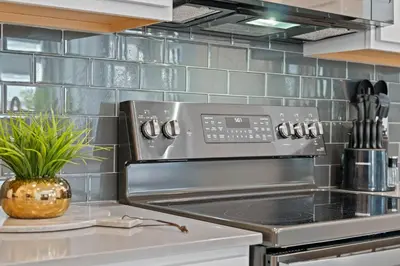 a kitchen with a stainless steel stove top oven at Beautiful Family Villa - Pool and Hot Tub - Near Disney World in Kissimmee