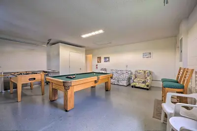 a room with a pool table and some chairs at about 5 Mi to Theme Parks Kissimmee Home with Pool in Orlando