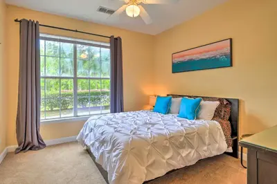 a bedroom with a bed and a large window at Sun-Soaked Kissimmee Gem with Resort Amenities! in Kissimmee