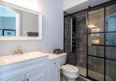 a bathroom with a toilet and a sink and a shower at South Facing Pool with Stunning Lake View - Family Friendly Home - Nr Disney in Kissimmee