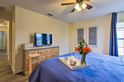 a bedroom with a blue bed with a tv on a dresser at Less Than 5 Mi to Disney World Resort Home for Families! in Kissimmee