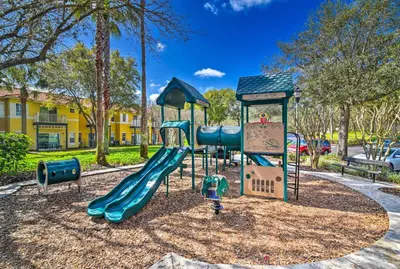 a playground with a slide in a park at Less Than 5 Mi to Disney World Resort Home for Families! in Kissimmee