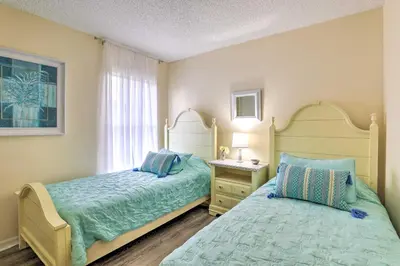 a bedroom with two beds next to a window at Less Than 5 Mi to Disney World Resort Home for Families! in Kissimmee