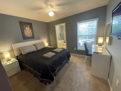 a bedroom with a bed and a desk and a window at 3 Bedroom Villa with Poolside Cinema and Games Room Close to theme Parks sleeps 6 in Orlando