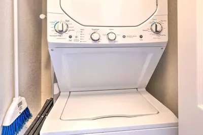 a white stove in a refrigerator with a broom at Disney-Inspired Townhome with Private Hot Tub! in Orlando