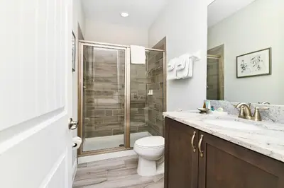 a bathroom with a shower and a toilet and a sink at Utopic Home With Themed Rooms, Game And Media Room And Waterpark & Resort Access Near Disney At Encore Resorts Reunion - 270Cl in Kissimmee