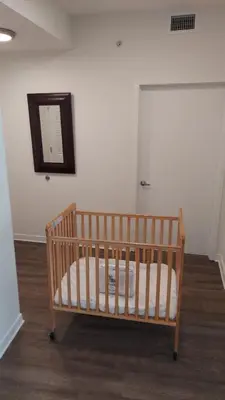 a crib in a room with a mirror at Hotel Apt at Celebration 10 min from Disney MH225 in Orlando