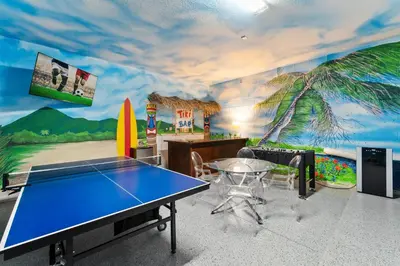 a room with a ping pong table and a mural at Fresh Amazing Family Home. Private Pool. Game Room. Sleeps 24 in Kissimmee