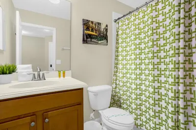 a bathroom with a toilet and a shower curtain at Fun Family Villa Pool BBQ Near Disney World 5BR in Kissimmee