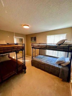 a bedroom with two bunk beds and a window at Grand Villas of Island 3BR Condo near Disney Parks and Universal in Kissimmee