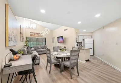 a kitchen and living room with a table and a couch at 3648 Orlando Vacational Apartment in Orlando