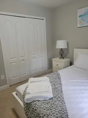a bedroom with a bed with two white towels on it at Paradise Villa Disney Staycation Pool, Fun & Resort Access in Kissimmee