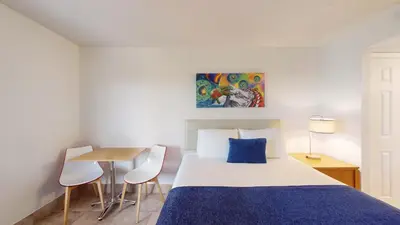 a bedroom with a bed and a table with chairs at Park Royal Orlando in Kissimmee