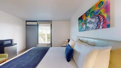 a bedroom with a large bed and a window at Park Royal Orlando in Kissimmee