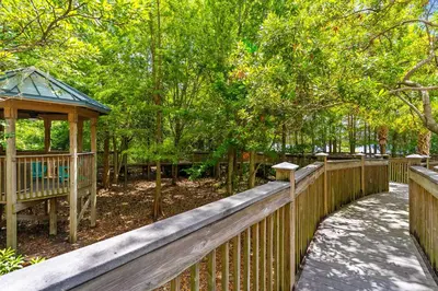 a wooden fence with a gazebo in a park at Luxury Condo with Huge Private Balcony on Lake Bryan in Orlando