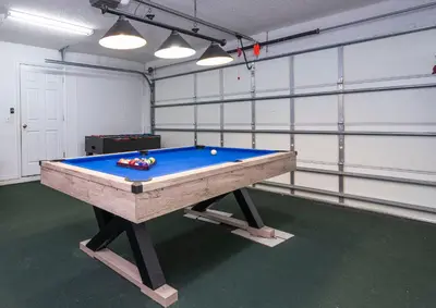 a room with a pool table in it at 133 Beautiful home with lake view in Kissimmee