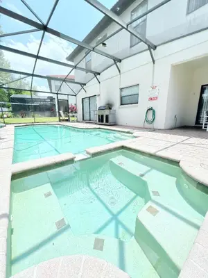 a swimming pool with blue water in a building at Gone 2 Florida Vacation Homes in Orlando