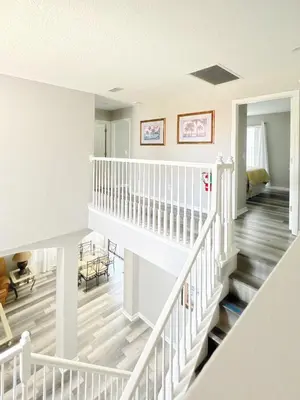 a staircase in a home with white railings at Gone 2 Florida Vacation Homes in Orlando
