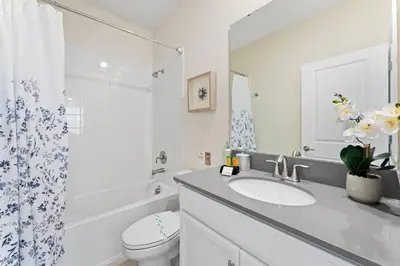 a bathroom with a sink and a toilet and a shower at Sophisticated 6BR at Storey Lake SL2766 in Kissimmee