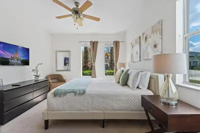 a bedroom with a bed and a ceiling fan at Ground Floor Gathering up to 9 guests BL387 in Kissimmee