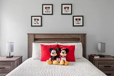 two mickeys are sitting on top of a bed at Enjoy Disney 3BRs at Villas of Somerset VS2745 in Kissimmee
