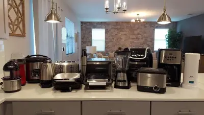 a kitchen counter with many appliances on it at Luxury Decor 6BR at Storey Lake sleeps 16 SL2945 in Kissimmee