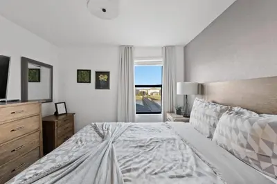 a bedroom with a large bed and a window at Luxury Decor 6BR at Storey Lake sleeps 16 SL2945 in Kissimmee