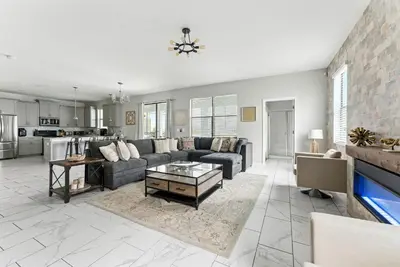 a living room with a couch and a table at Luxury Decor 6BR at Storey Lake sleeps 16 SL2945 in Kissimmee
