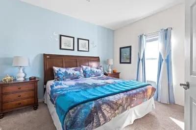 a bedroom with a bed and a dresser and a window at 4BR Community pool across the street WL8989 in Kissimmee